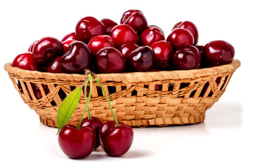cherries in a wicker basket isolated on white background