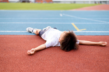 Boy lay on the running track