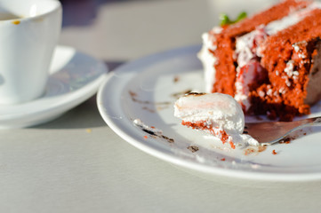 Sunny cup of coffee and cake in cafe on the table outside terrace background