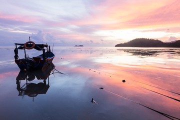 Sunrise and Sunset with by the beach with a boat in Penang Malaysia