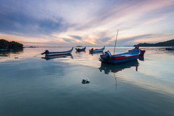 Sunrise and Sunset with by the beach with a boat in Penang Malaysia