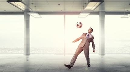 Obraz na płótnie Canvas Playing football in office