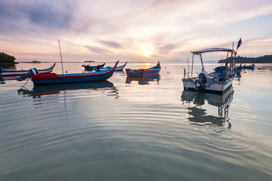 Sunrise and Sunset with by the beach with a boat in Penang Malaysia