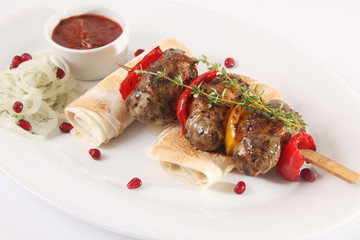 Sausages on a skewer with pita and sauce