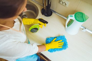 Kitchen cleaning concept. Female hands in gloves closeup