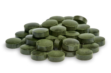 Spirulina pills (superfood) isolated on white background.