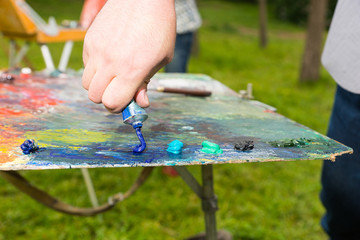 Artist Squeeze Paint On The Palette