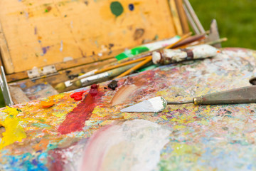 Obraz premium Close up of painter's tools on a sketchbook in the open air