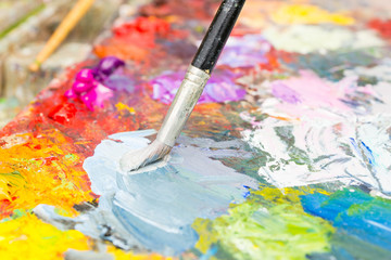 Professional paintbrush mixing colors