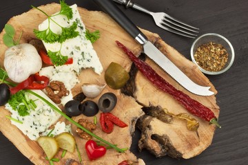Danish blue. Blue cheese close up on an old wooden table with spices. Preparing food blue cheese. Cheese on the kitchen table. Noble rot. Cheese with mold delicacy.
