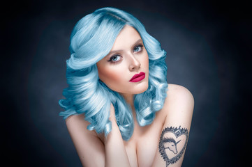 Studio beauty portrait of a girl with blue hair