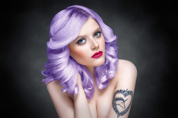 Studio beauty portrait of a girl with purple hair