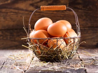 Fotobehang fresh eggs in a basket © Nitr