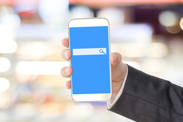Businessman hand holding smart phone with search bar on screen