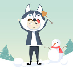 Boy wearing siberian husky costume making snowman, siberian husk