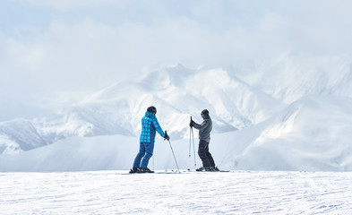 two skiers talking about something alone