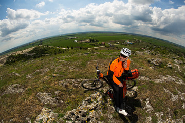 Obraz premium Young Male Cyclist Talking On Cell Phone