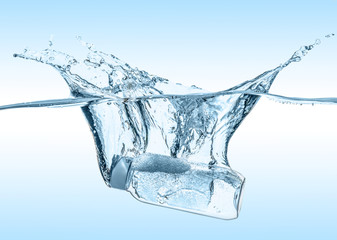 The moisturizing shampoo, cosmetic liquid, tonic falls into the blue water with big water splash on...