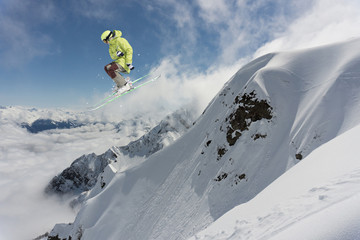 Ski rider jumping on mountains. Extreme ski freeride sport.