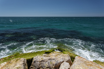 The waves beat against the rocks on the shore of the Atlantic Ocean.