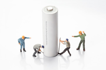 miniature people  - workers moving and recycle batteries, 
isolated on white
