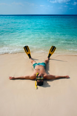 Man, relaxing in yellow black flippers fins and mask. © yaroslavasg