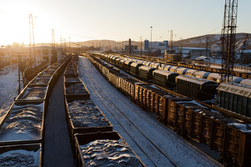 Fototapeta na wymiar Freight trains with coal in the rays of the sun in Murmansk.