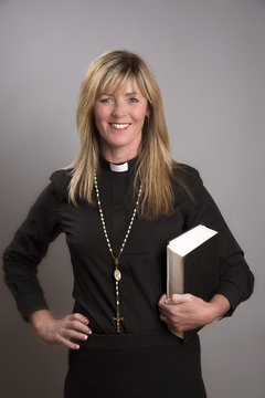 Portrait Of A Female Clergy Wearing A Black Shirt And Dog Collar