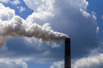 Pipe heavy industry factory emits into the air precipitation, smog and gas, polluting the planet.