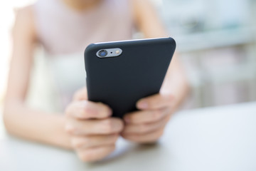 Woman sending sms on cell phone