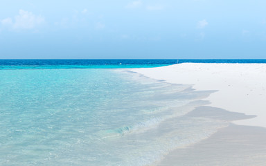 Splash of waves on the white sand beach. Maldives, Ari Atoll.