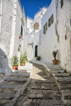 Fototapeta Narrow old urban street in italian town