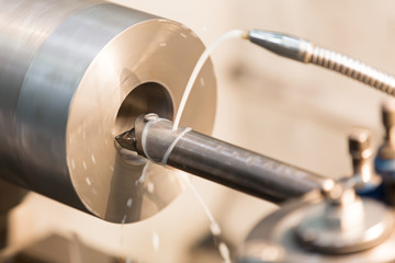 Hole cutting by boring tool on lathe turning machine with cooling lubricant concentrate emulsion