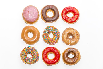 Colorful glazed donuts collection isolated on white background, top view