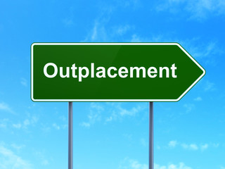 Finance concept: Outplacement on road sign background