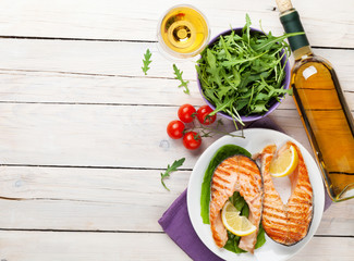 Grilled salmon and white wine on wooden table - Powered by Adobe