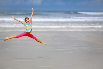 Fototapeta na wymiar Girl jumping on the beach