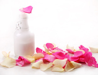 Fototapeta na wymiar bottle and rose petals