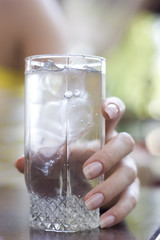 glass with soda and female hand