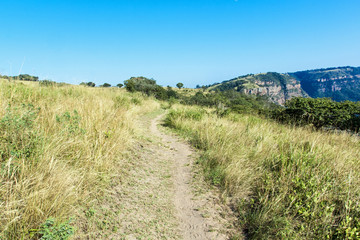 Empty Hiking trail  Leading Towards  Distant  Rocky Cliff
