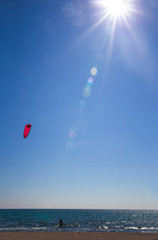 Athletic man riding on kite surf board on a sea waves