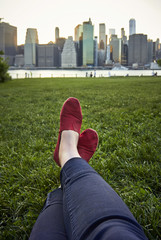 Foot in sandals on green grass