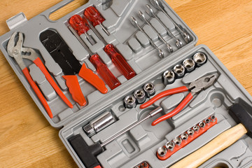 Toolbox with different instruments on wooden background
