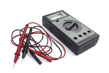 Digital multimeter with LCD display isolated on white background. Red and black wires. 