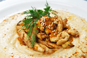 Hummus plate with copyspace at wood, top view