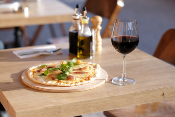 Pizza and red wine in restaurant