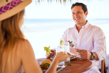 Young couple eating lunch at the beach