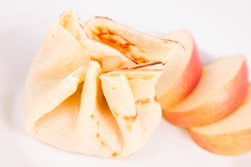 Pancake sack stuffed with braised apples decorated with apples