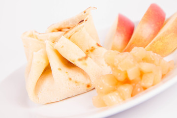 Pancake sack stuffed with braised apples decorated with apple slices