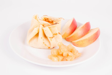 Pancake sack stuffed with braised apples decorated with apple slices